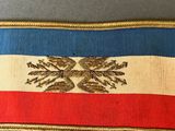 a close up of a red, white, and blue ribbon with a gold eagle on it