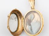 an image of a gold locke with a picture of a woman in it