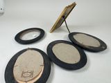 three mirrors and a picture frame sitting on a table