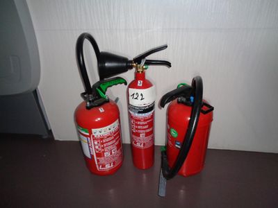 three fire extinguisors sitting on a table next to each other