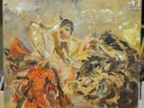 un tableau représentant une femme et un taureau posé sur une table