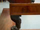 a statue of a man sitting on top of a wooden bench