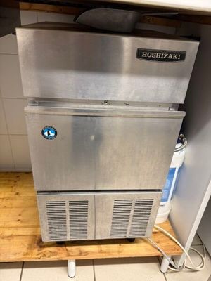 a stainless steel refrigerator in the corner of a kitchen