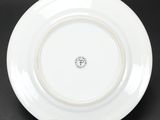 a close up of a plate on a black surface