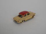 yellow toy car with red roof on a white surface
