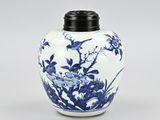 a blue and white vase with flowers and birds on it