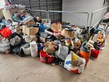 a large pile of garbage on the ground next to a building