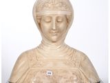 a marble bust of a woman with a hat on her head