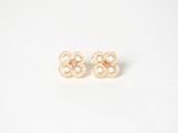 a pair of gold earrings with pearls on a white background