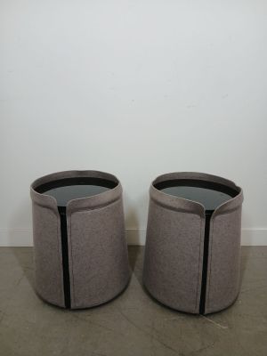 a pair of round stools with a black stripe on the top