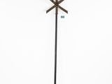 a tall metal pole with a green sign on top of it