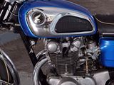 a blue motorcycle that is parked on the side of the street