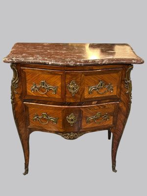 a marble top chest of drawers with a marble top