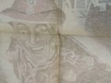 a newspaper with a picture of a man in a fireman ' s hat on it