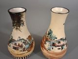 two vases that are sitting on a table