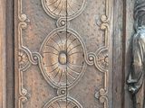 a wooden door with a carving of a man and a woman on it