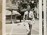 a black and white photo of a man walking down the street