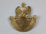 an image of a gold plate with a bird on top of it