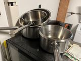 pots and pans on top of a stove in a kitchen