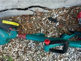 a green lawn mower that is laying on the ground