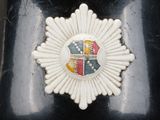 a close up of a badge on a black vase