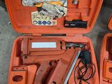 two orange tools in a case on the ground