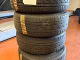 four tires stacked on top of each other in a garage
