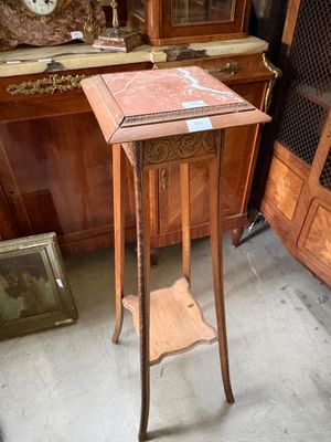 une petite table sur laquelle est posée une horloge, dans une pièce