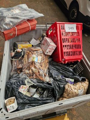 many bags of food in a plastic container on the street