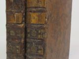 two old books that are stacked on top of each other