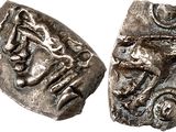 a silver coin with an image of a man and a woman on it