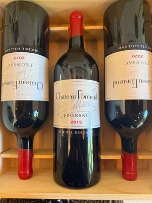 three bottles of wine sitting in a wooden box