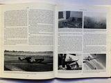an open book with a picture of a plane on it