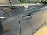 a close up of a car door handle with a sticker on it