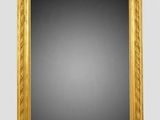 a gold framed mirror with a black background