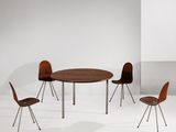 two chairs and a table in a white room with a white wall