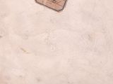 a white vase that has a tag on it