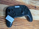 a video game controller sitting on a wooden table