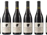 six bottles of red wine are lined up in a row