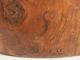 a close up of a wooden bowl on a white surface