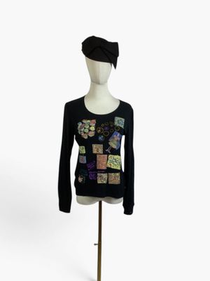 black long sleeved top with multicolored patches on the chest