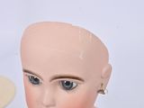 a close up of a mannequin head on a table
