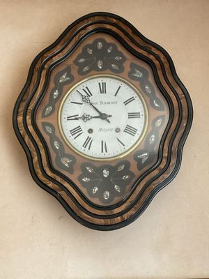 a clock on the wall with roman numerals on it