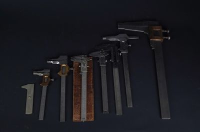 cinq types de marteaux différents sur une surface noire