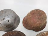 several different types of helmets sitting on a white surface