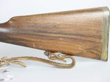 a wooden rifle with a rope attached to it