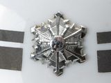 a close up of a badge on a white car
