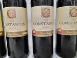 four bottles of wine are lined up on a table