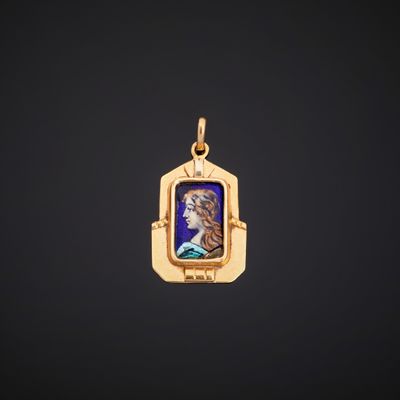 a gold pendant with a portrait of a woman in a blue dress