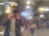a man taking a picture of himself through a broken window